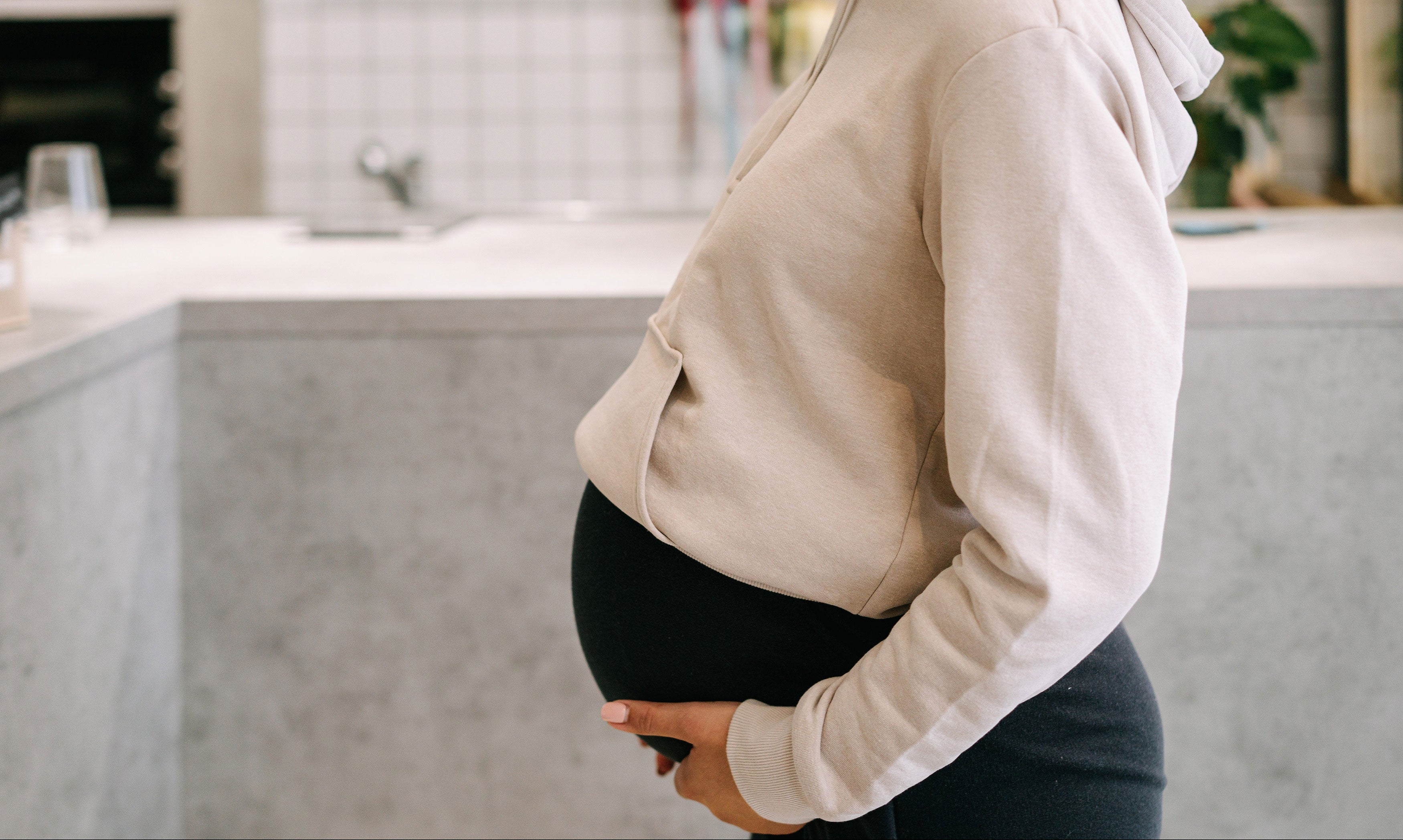Pregnant woman holding her pregnancy bump