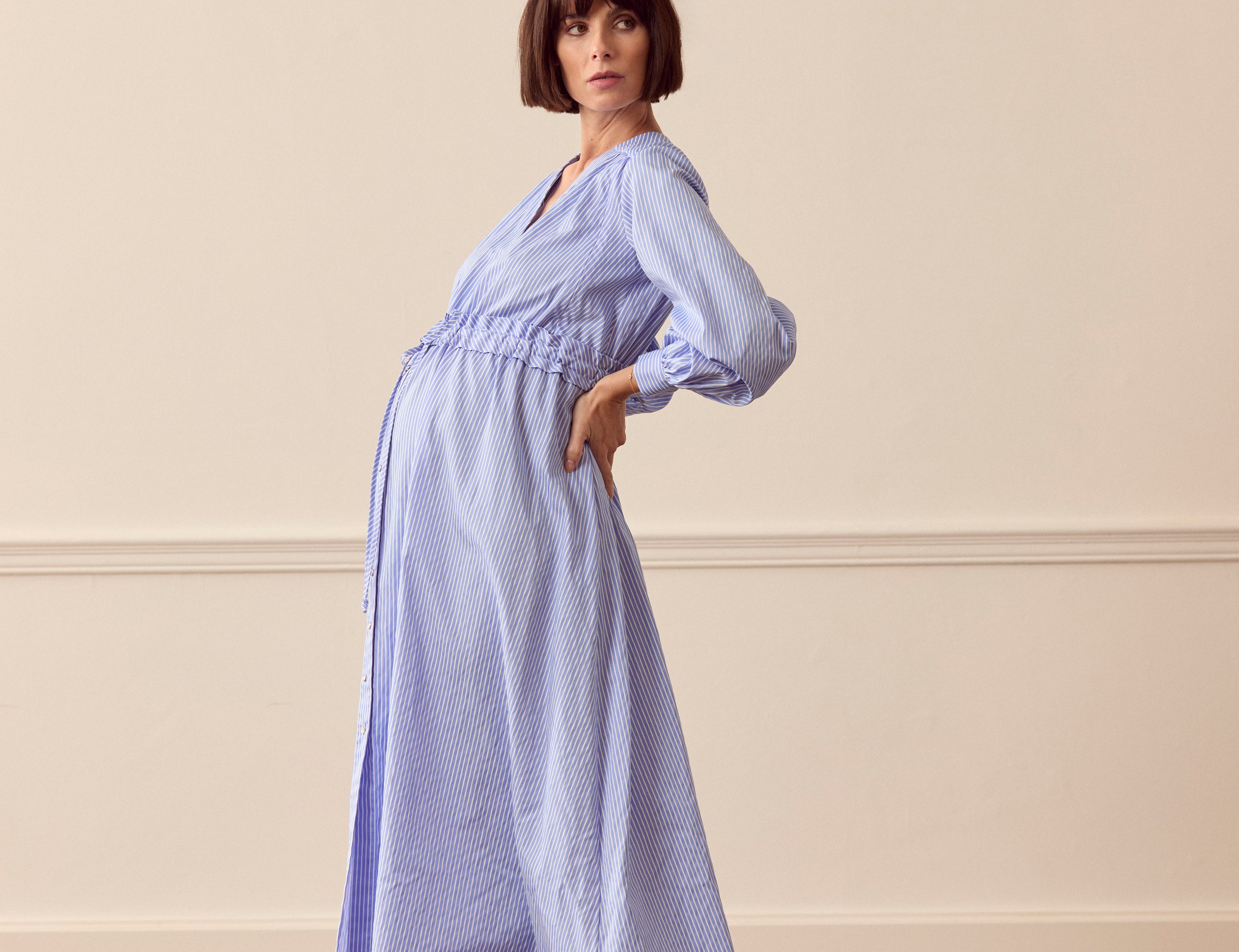 pregnant women wearing pin stripe breastfeeding dress