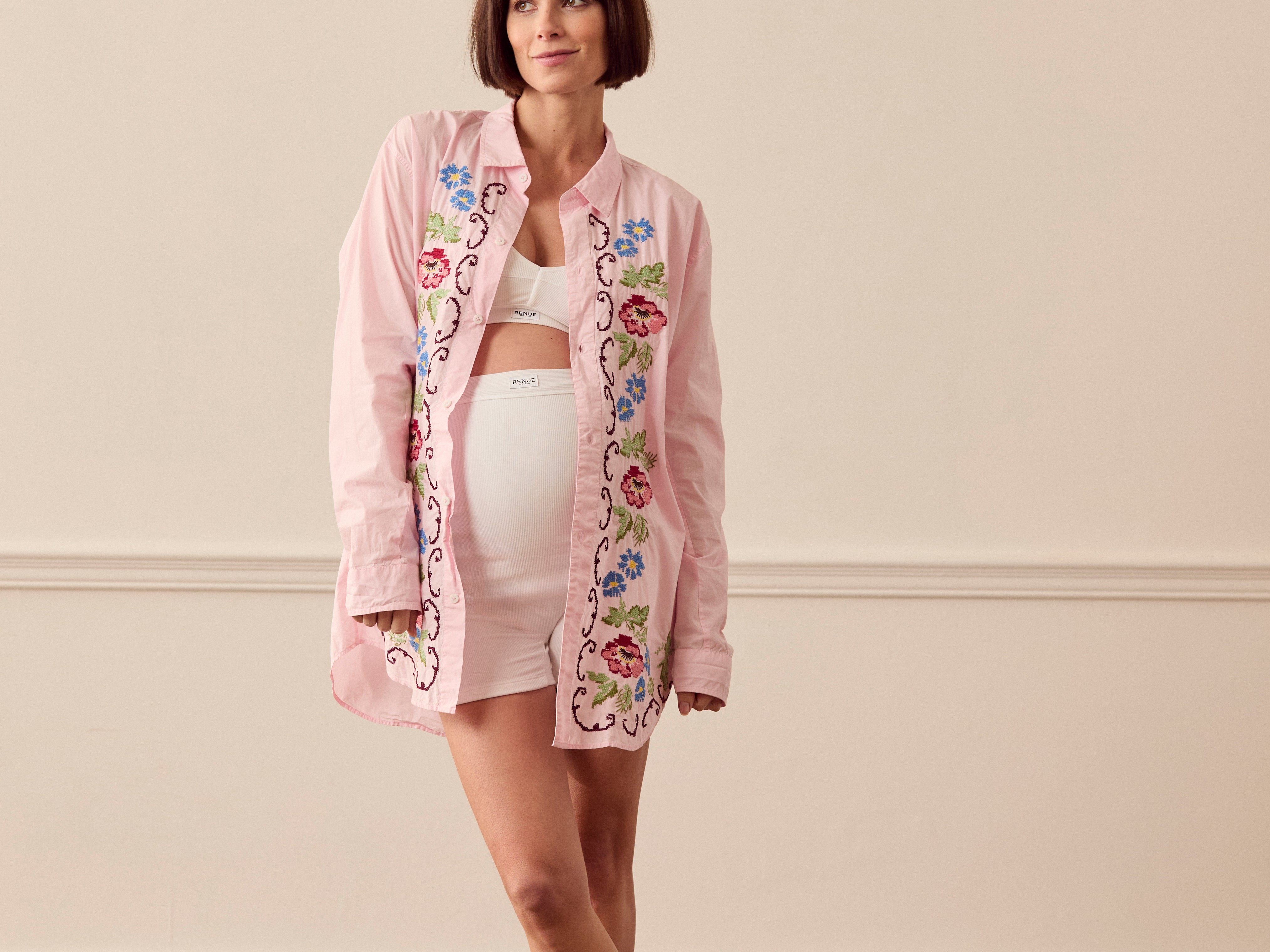 Pregnant woman wearing pink lounge shirt