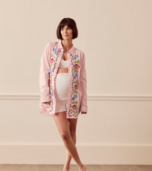 Pregnant woman wearing pink lounge shirt
