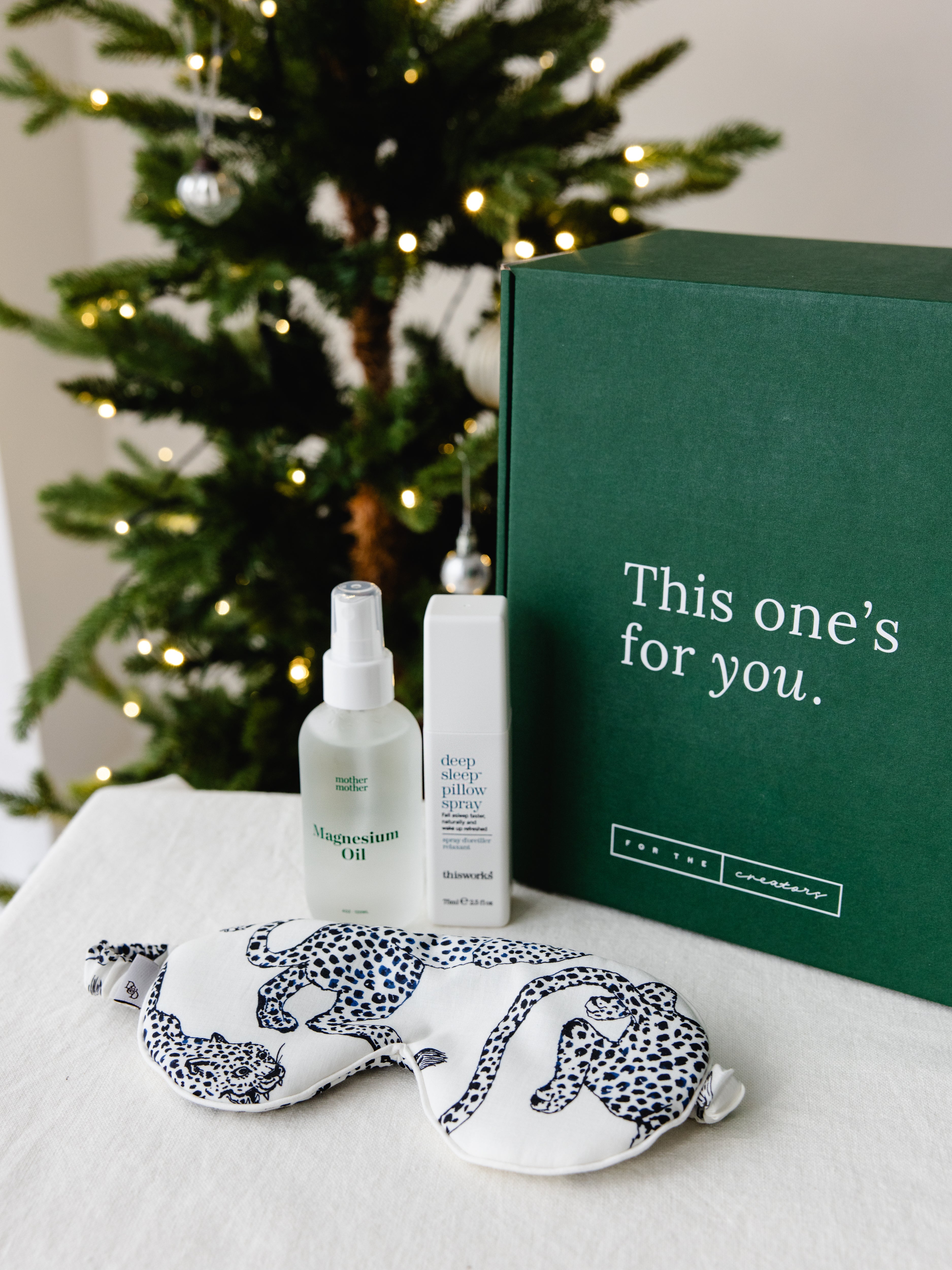 Gifts for new mums in front of a Christmas tree