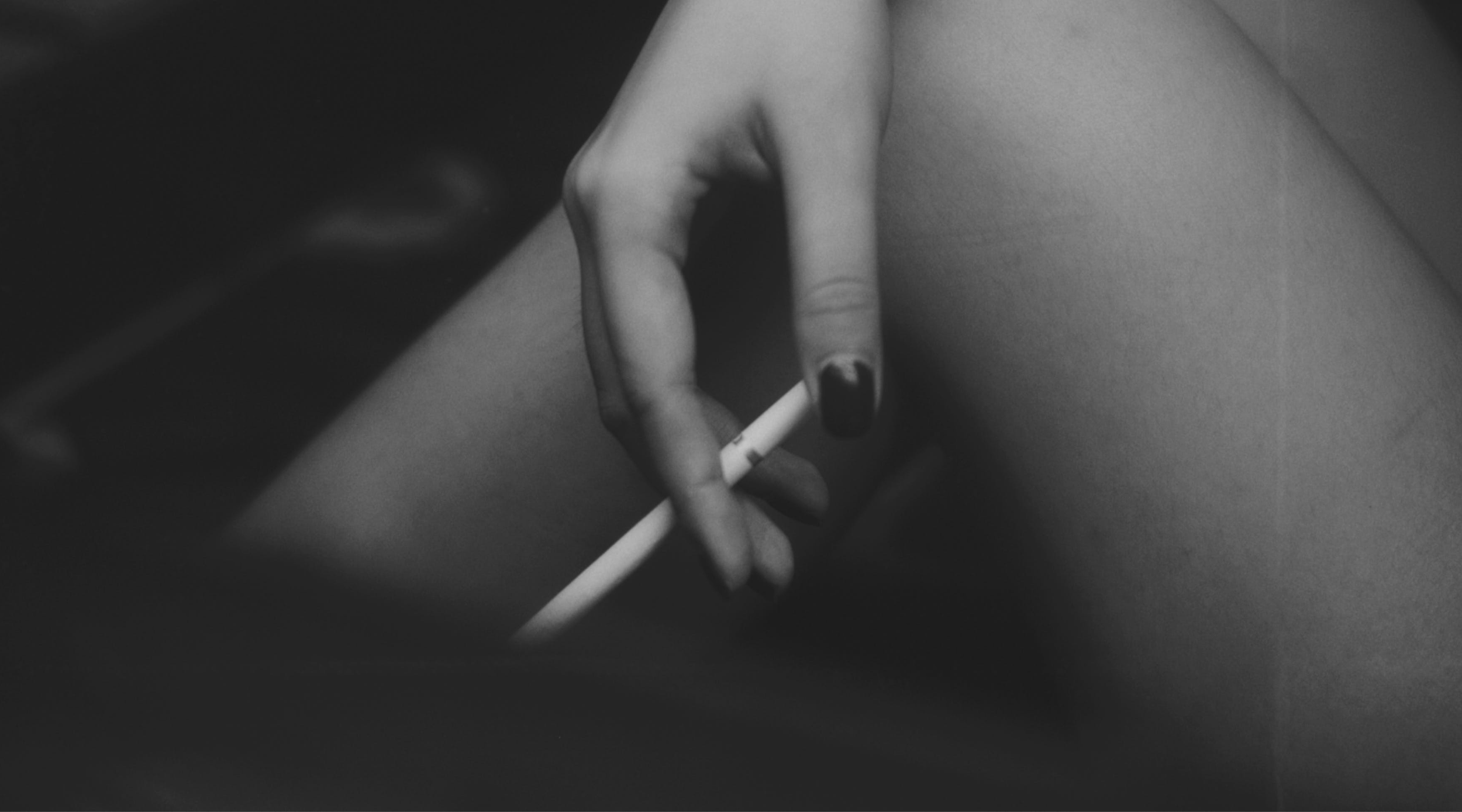 Hand holding an unlit cigarette