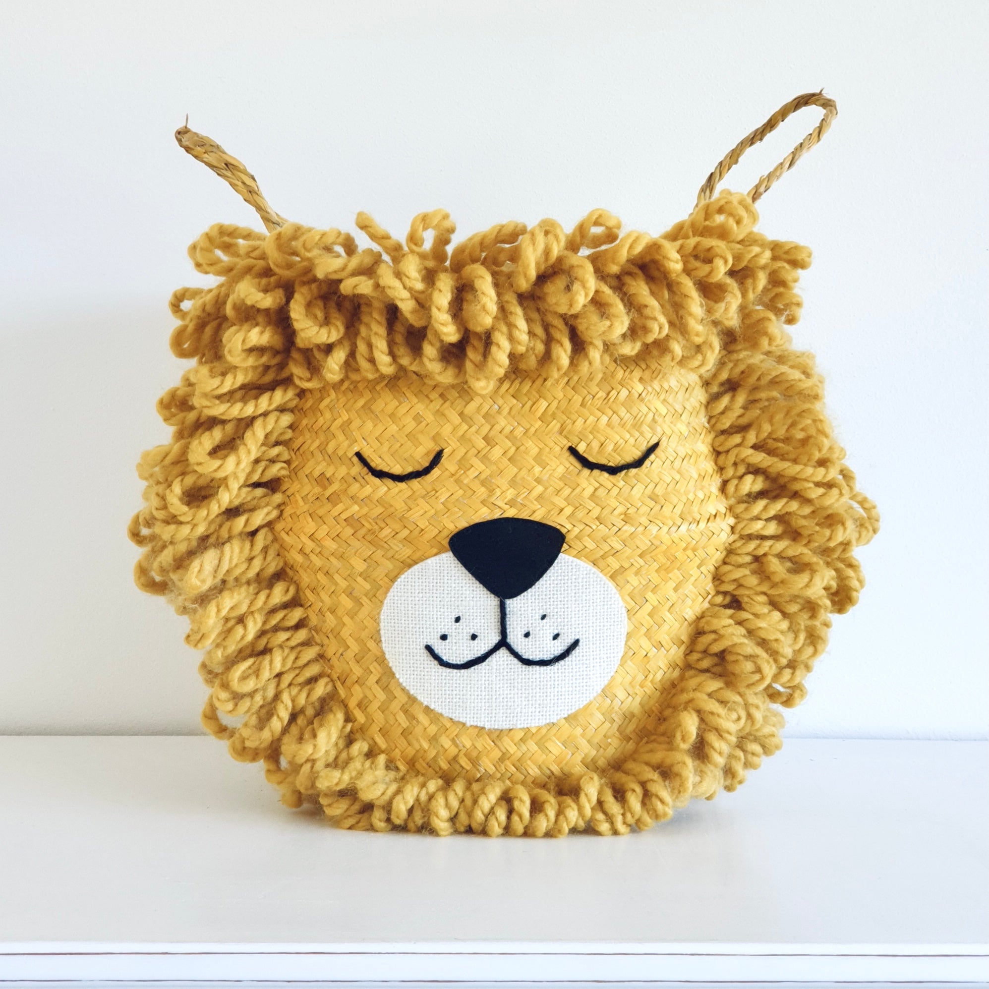Bellybambino yellow lion belly basket, handwoven from seagrass with hand embroidered detail