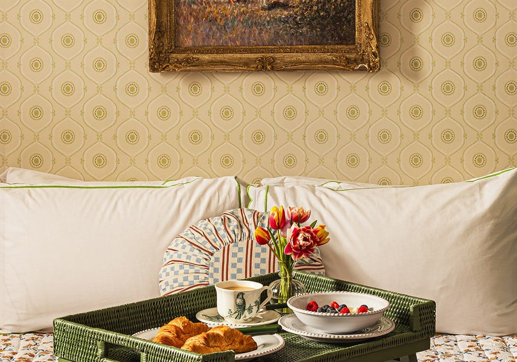 Casa by Josephine Jenno green rattan breakfast tray set with breakfast on a bed