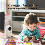 Child playing with a toy on a table next to a security camera with text 'Know your baby is ok anytime anywhere in the house'.