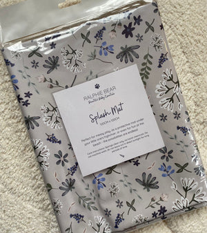 Ralphie Bear floral splash mat packaging on a carpeted floor