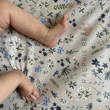 Floral patterned paper with 'Ralphie Bear' branding on a white background