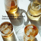 Four glasses of iced and warm beverages on a white surface with text about a chef's taste profile.