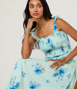 Blue floral midi dress on female model sitting