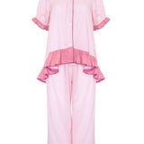 A light pink two-piece pajama set featuring a short-sleeve button-front top with ruffled trim and matching wide-leg pants with ruffled hems, shown on a plain white background.