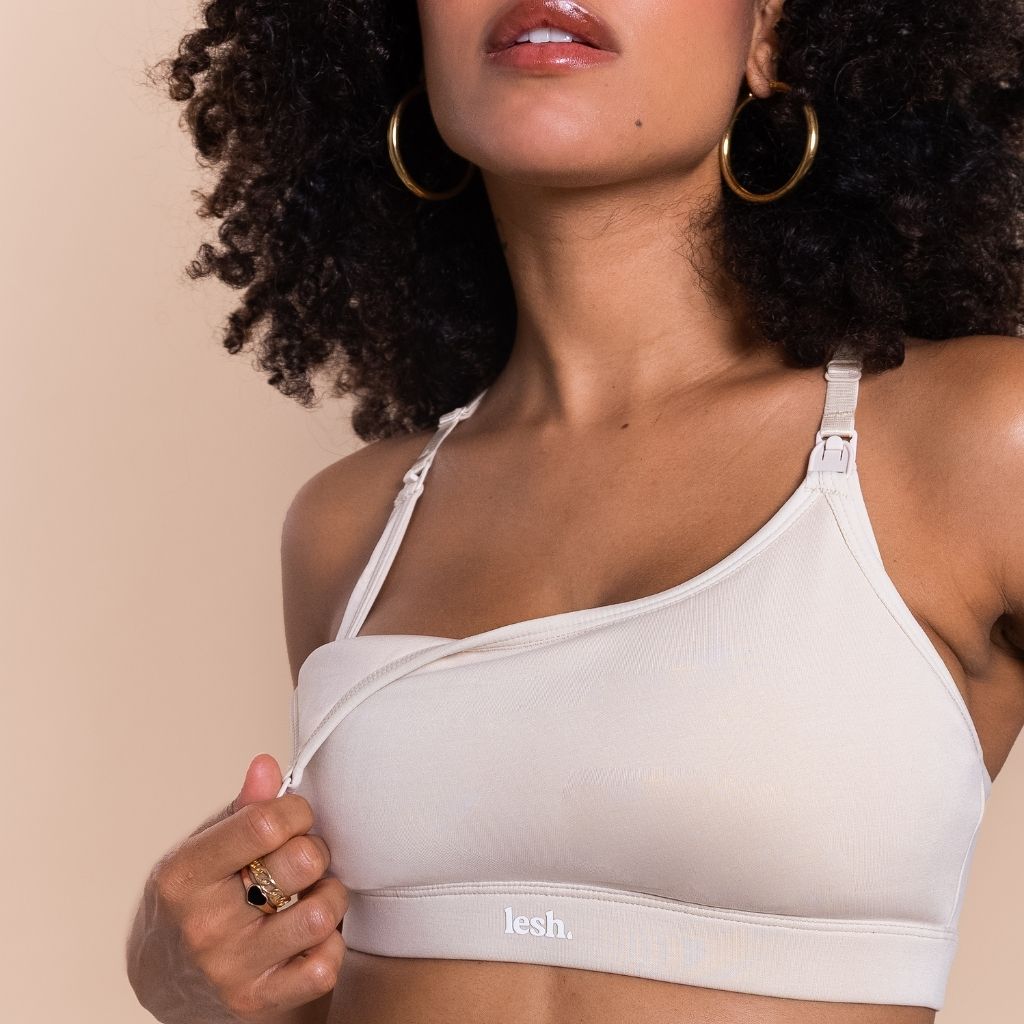 Woman wearing a beige bralette with 'lesh' branding on a beige background