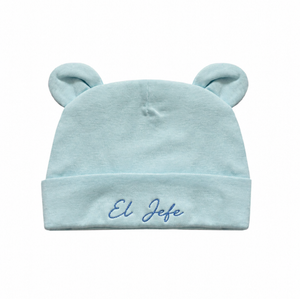 Light blue baby hat with bear ears and 'El Jefe' embroidery on a white background