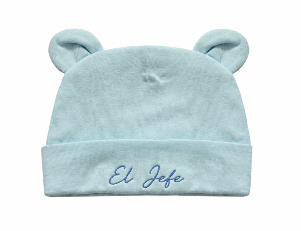 Light blue baby hat with bear ears and 'El Jefe' embroidery on a white background