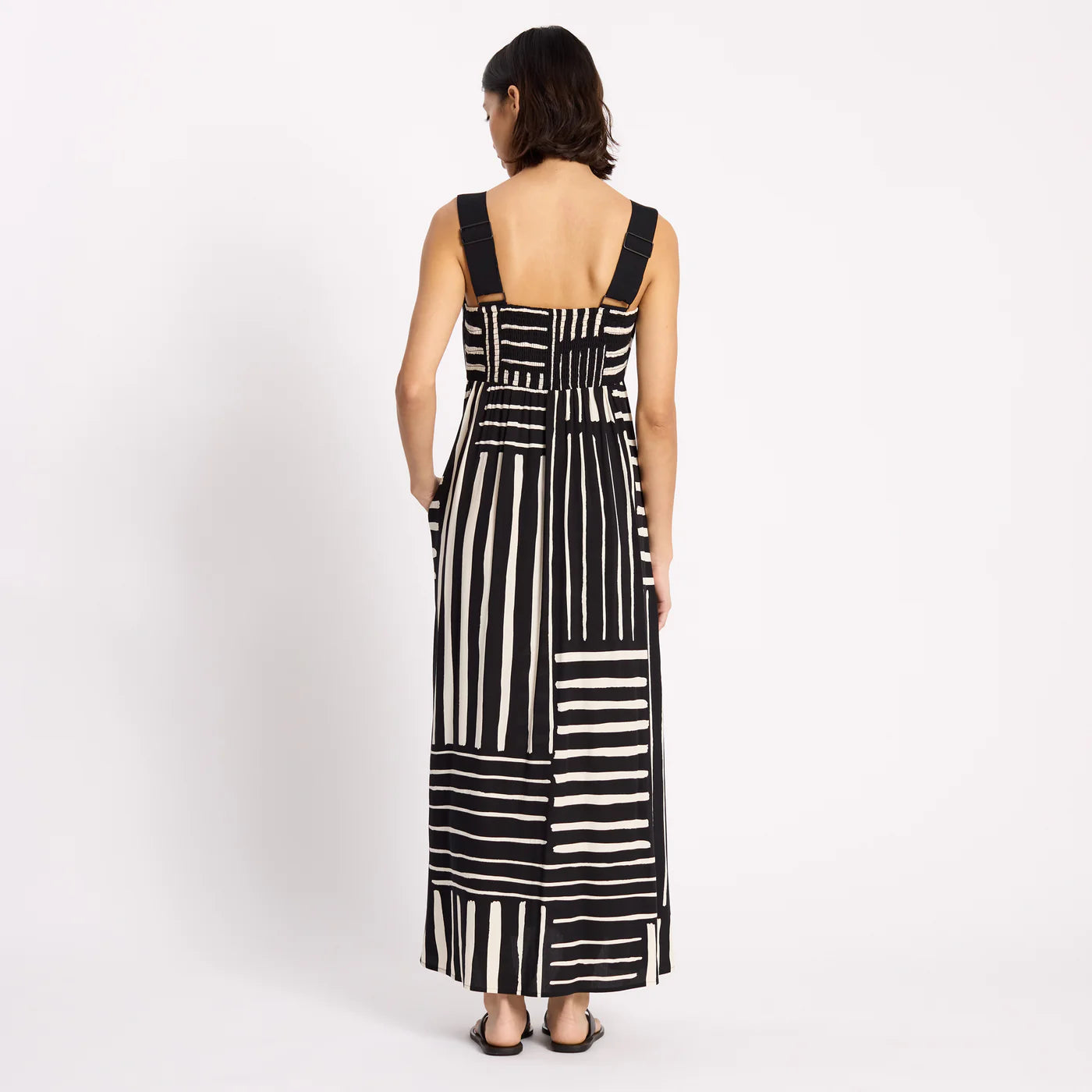 Woman wearing a black and white striped dress on a white background