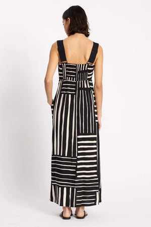 Woman wearing a black and white striped dress on a white background