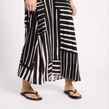 Black and white striped dress worn by a person on a white background