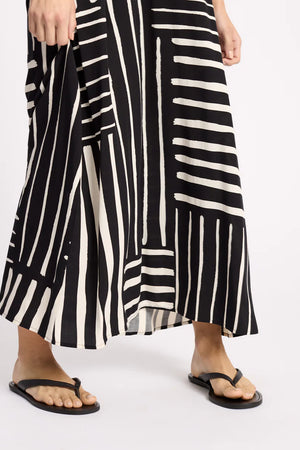 Black and white striped dress worn by a person on a white background