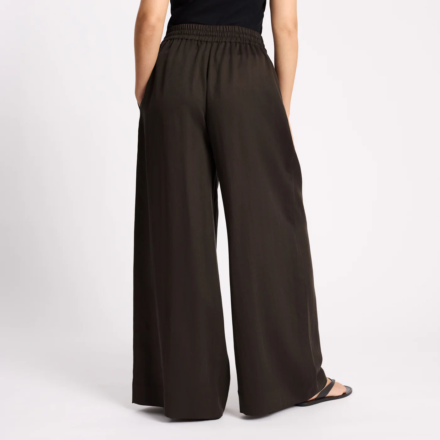 Brown wide-leg pants worn by a person on a light gray background