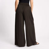 Brown wide-leg pants worn by a person on a light gray background