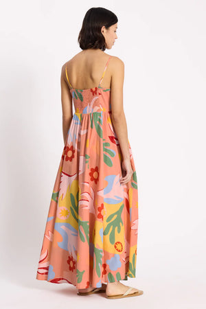 Woman wearing a colorful floral dress on a white background
