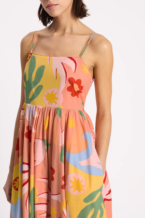 Woman wearing a colorful floral dress on a white background