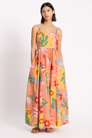 Woman wearing a colorful floral dress on a white background