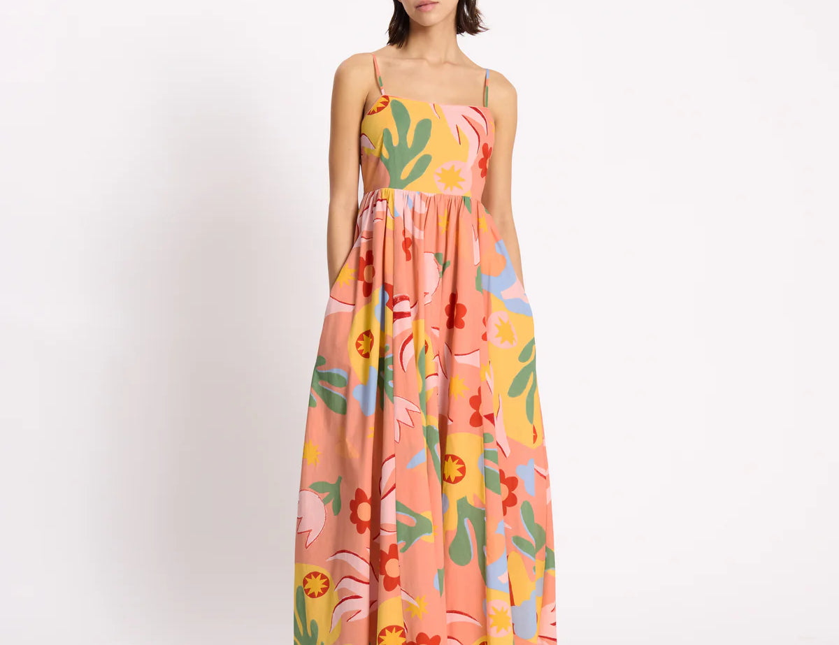 Woman wearing a colorful floral dress on a white background