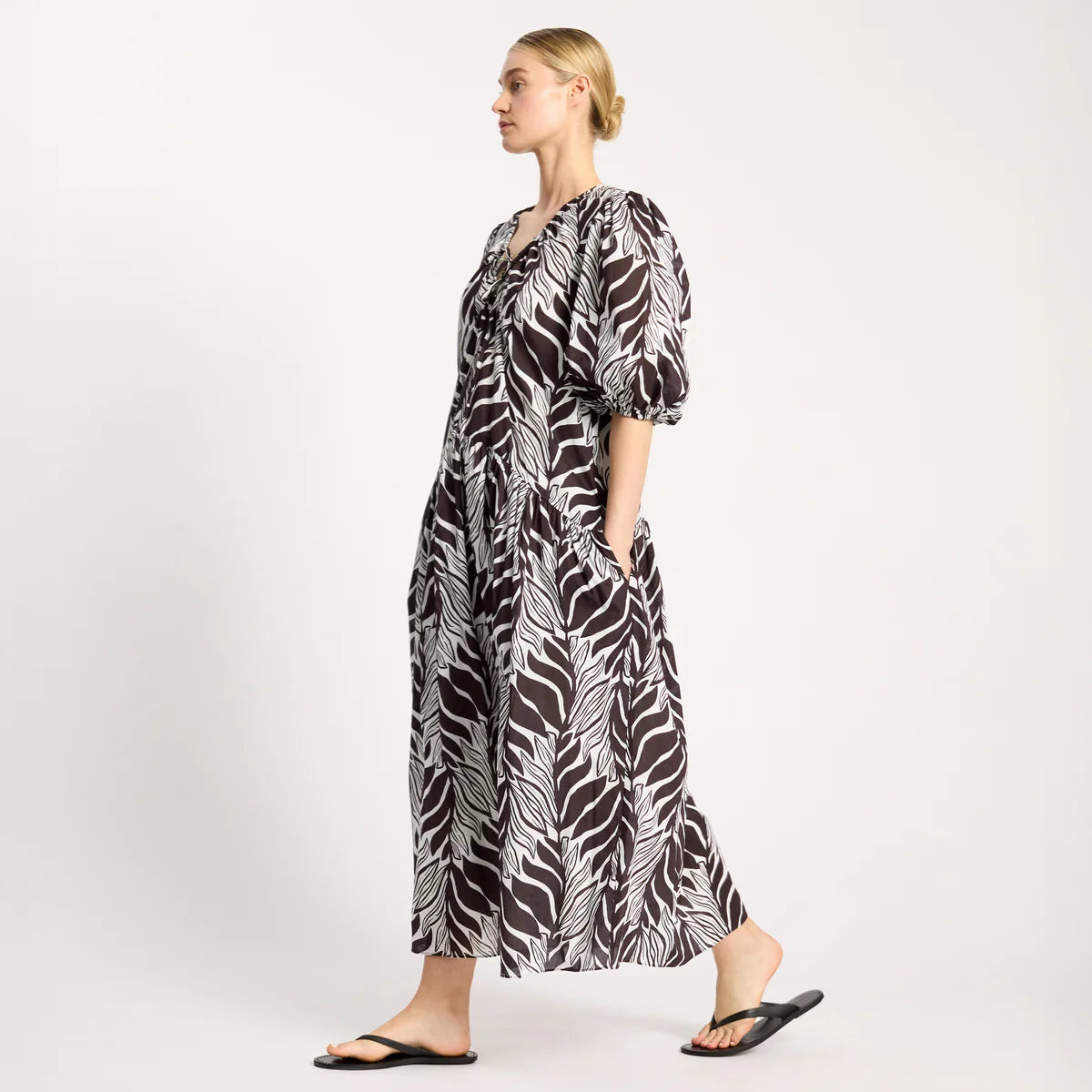 Woman wearing a zebra print dress on a white background