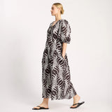 Woman wearing a zebra print dress on a white background