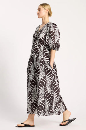 Woman wearing a zebra print dress on a white background