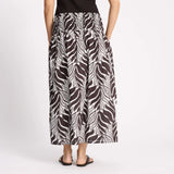Person wearing a zebra print skirt on a white background