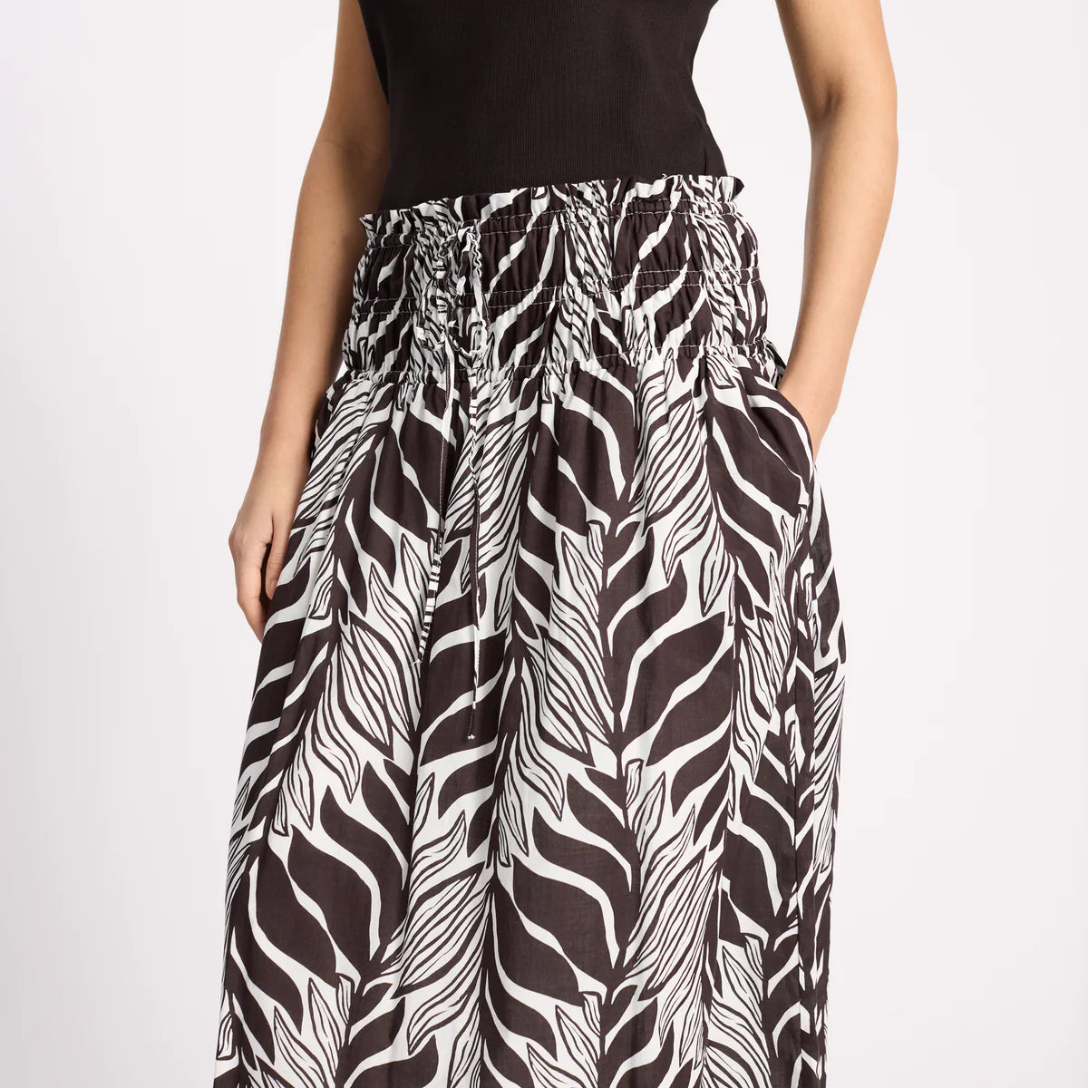 Zebra print pants worn by a person on a white background