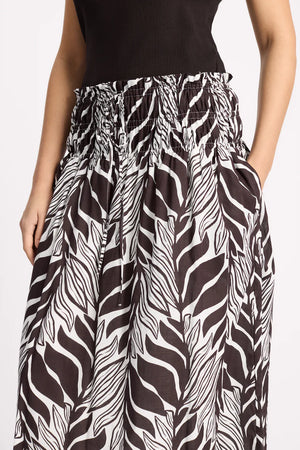 Zebra print pants worn by a person on a white background