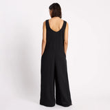 Person wearing a black jumpsuit on a white background