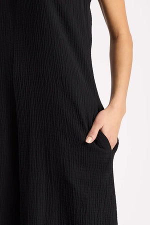 Black jumpsuit with pockets with a plain background