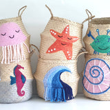 Shell belly basket, large, stacked with five other sea-creature baskets including jellyfish, starfish, crab and wave