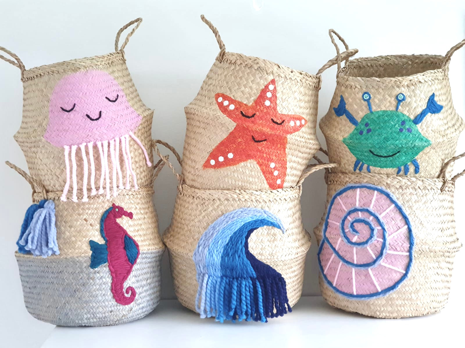 Shell belly basket, large, stacked with five other sea-creature baskets including jellyfish, starfish, crab and wave
