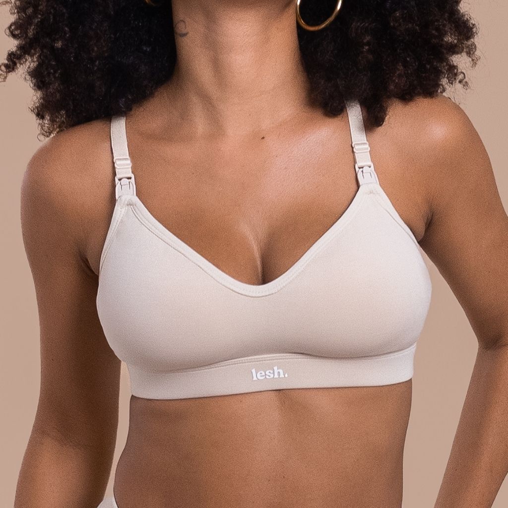 Woman wearing a beige bra with 'lesh' branding on a beige background