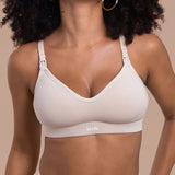 Woman wearing a beige bra with 'lesh' branding on a beige background