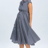 Woman wearing a blue and white striped dress on a light gray background
