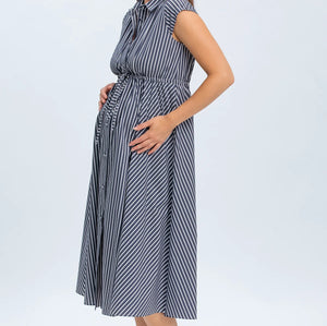 Woman wearing a striped dress on a white background