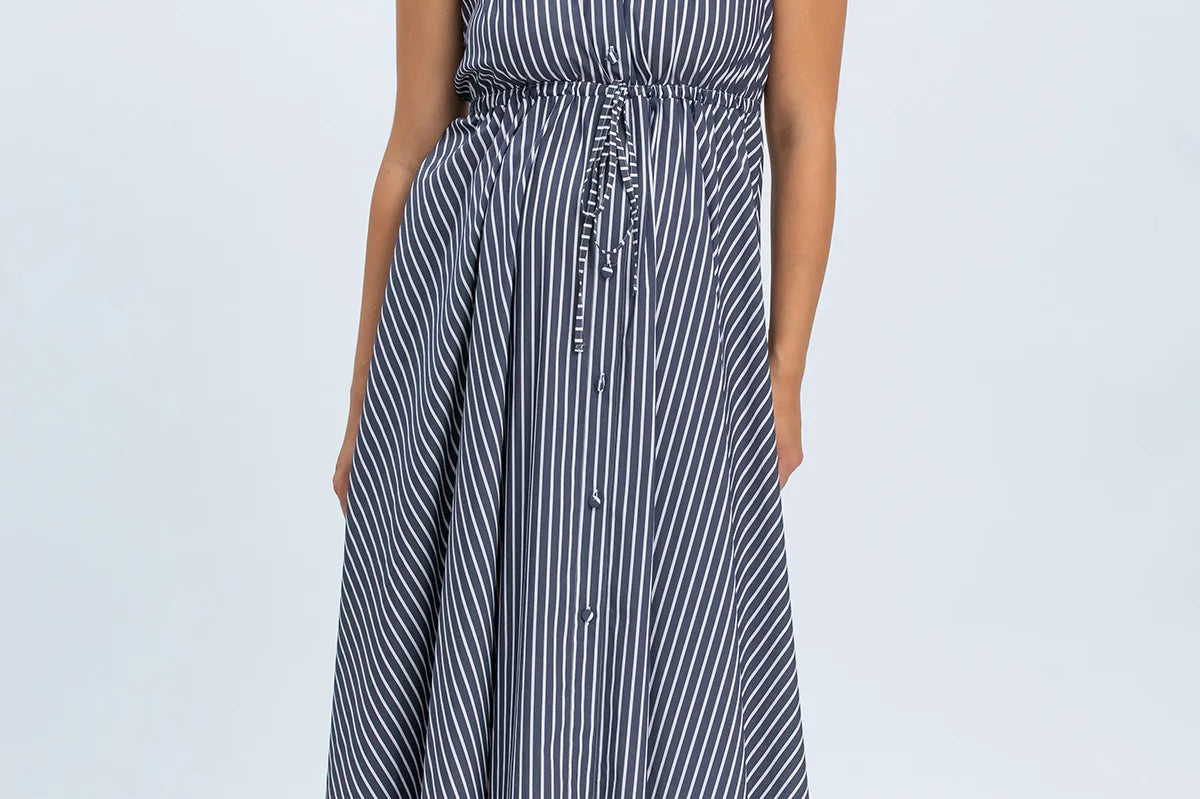 Woman wearing a blue and white striped dress on a white background