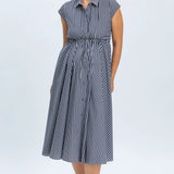 Woman wearing a blue and white striped dress on a white background