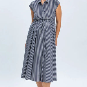 Woman wearing a blue and white striped dress on a white background