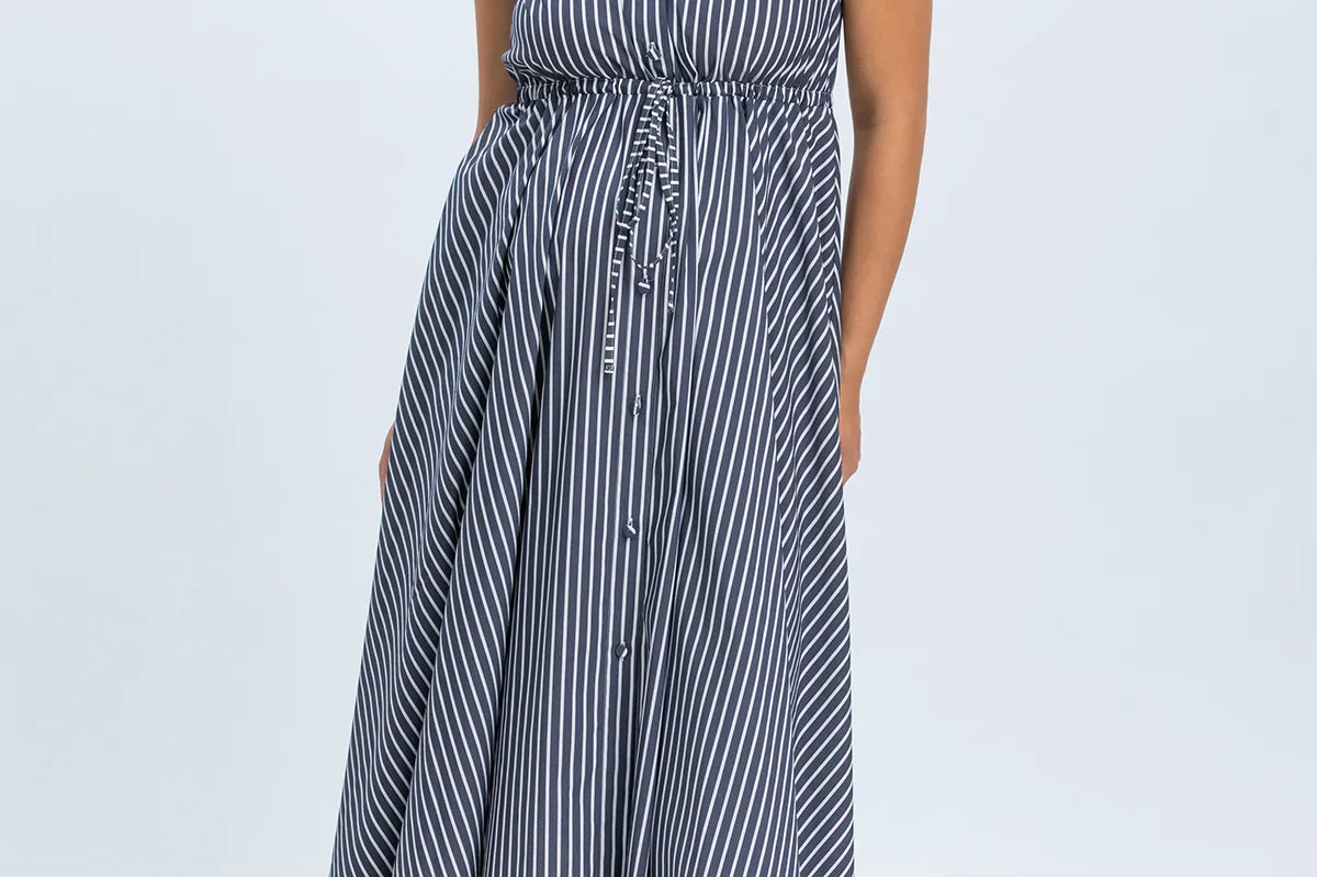 Woman wearing a blue and white striped dress on a white background