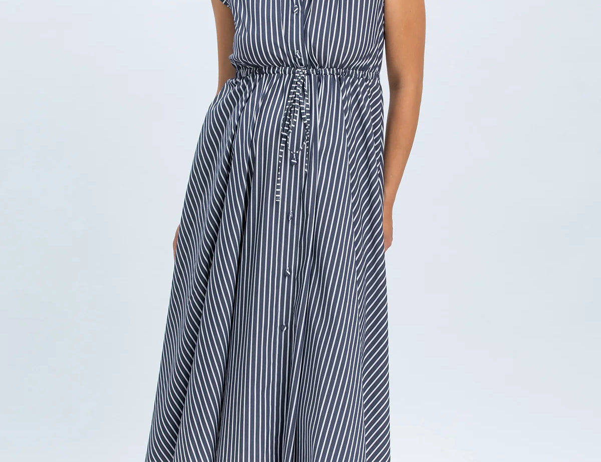 Woman wearing a blue and white striped dress on a white background