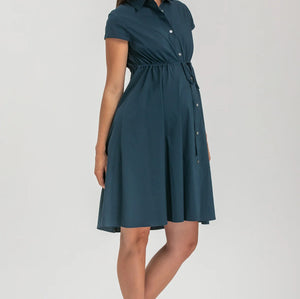 Pregnant woman wearing navy blue shirt dress on grey background