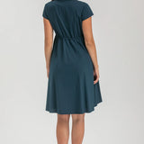 Pregnant woman wearing navy blue shirt dress on grey background
