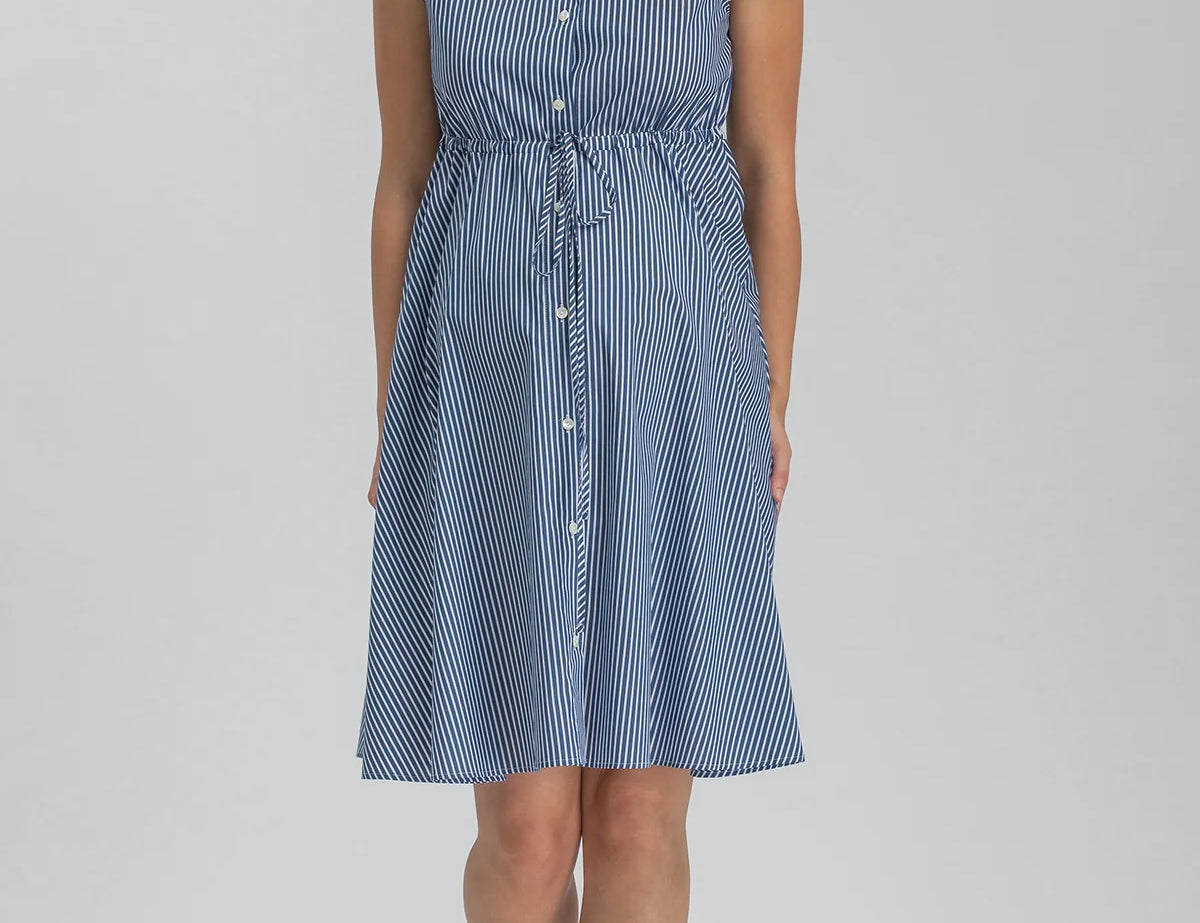 Woman wearing blue stripe shirt dress on grey background