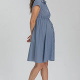 Woman wearing blue stripe shirt dress on grey background